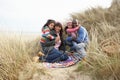 Family Sitting In Dunes On Winter Beach Royalty Free Stock Photo