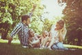 family sitting on grass in the meadow together and enjoyin Royalty Free Stock Photo