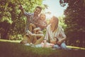 family sitting on grass in the meadow together and enjoyin Royalty Free Stock Photo