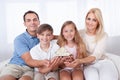 Family Sitting Holding Miniature Model Of House Royalty Free Stock Photo