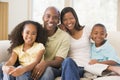 Family sitting in living room smiling Royalty Free Stock Photo