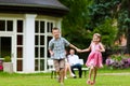 Family sitting and playing in front of their home Royalty Free Stock Photo