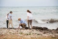 Family sitting on rock and watching the ocean Royalty Free Stock Photo