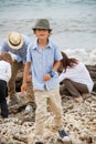 Family sitting on rock and watching the ocean Royalty Free Stock Photo