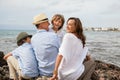 Family sitting on rock and watching the ocean Royalty Free Stock Photo