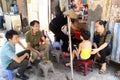 Family sitting on street in Hanoi, Vietnam