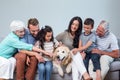 Family sitting on sofa with dog Royalty Free Stock Photo