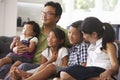 Family Sitting On Sofa At Home Watching TV Together Royalty Free Stock Photo