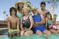 Family sitting at swimming pool Royalty Free Stock Photo