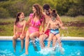 Family sitting by the swimming pool Royalty Free Stock Photo