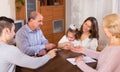 Family sitting at table with cards Royalty Free Stock Photo