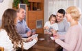 Family sitting at table with cards Royalty Free Stock Photo