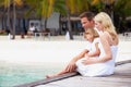 Family Sitting On Wooden Jetty Royalty Free Stock Photo