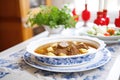 family-size serving of goulash soup in a large white dish