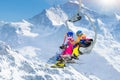 Family in ski lift in mountains. Skiing with kids Royalty Free Stock Photo