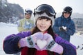 Family in Ski Resort, Daughter Showing Snow Heart Royalty Free Stock Photo