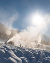 Family sledding under Snowmaking machine snow cannon Royalty Free Stock Photo