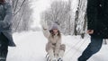 family sledding in winter. outdoor winter activity. Happy, laughing, playful family of 4 is enjoying of sledging their Royalty Free Stock Photo