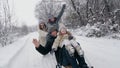 family sledding in winter. outdoor winter activity. Happy, laughing, playful family of 4 is enjoying of sledging their Royalty Free Stock Photo