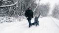 family sledding in winter. outdoor winter activity. Happy, laughing, playful married couple is enjoying of sledging on Royalty Free Stock Photo