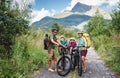 Family with small children cycling outdoors in summer nature. Royalty Free Stock Photo