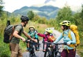Family with small children cycling outdoors in summer nature, resting. Royalty Free Stock Photo