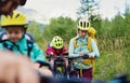 Family with small children cycling outdoors in summer nature, resting. Royalty Free Stock Photo