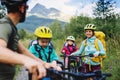 Family with small children cycling outdoors in summer nature, Tatra mountains Slovakia. Royalty Free Stock Photo