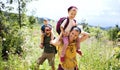 Family with small children hiking outdoors in summer nature. Royalty Free Stock Photo