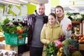 Family with small girl standing with full grocery cart in fruit shop Royalty Free Stock Photo