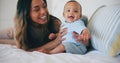 Family, smile and a mother on the bed with her baby in their home together for care or bonding. Children, love and a Royalty Free Stock Photo