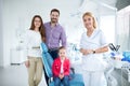 Family with a smiling young dentist Royalty Free Stock Photo
