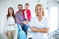 Family with a smiling young dentist Royalty Free Stock Photo