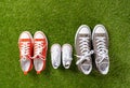 Family sneakers canvas mother father and child shoes on green grass in happy family lifestyle