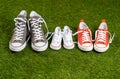 Family sneakers canvas mother father and child shoes on green grass in happy family lifestyle