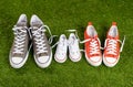Family sneakers canvas mother father and child shoes on green grass in happy family lifestyle