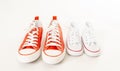 Family sneakers canvas shoes of father and child on white in single parent family concept Royalty Free Stock Photo