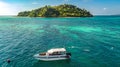 Family snorkeling near boat in clear tropical sea, aerial drone view from above, mother and kids snorkelers swimming in water Royalty Free Stock Photo