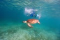 Family snorkeling with sea turtle Royalty Free Stock Photo