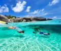 Family snorkeling in tropical water Royalty Free Stock Photo