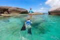 Family snorkeling in tropical water Royalty Free Stock Photo