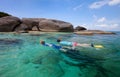 Family snorkeling at tropical water Royalty Free Stock Photo