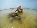 Family snorkeling with turtle