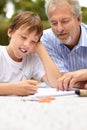 Family, son and father with homework outdoor for helping, learning and development with happiness at home. Man, child Royalty Free Stock Photo