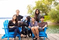 Family with special needs child sitting outdoors together in sum