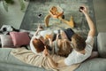 Family spending nice time together at home, looks happy and cheerful, eating pizza. Top view.