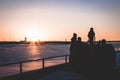 Family spending time during the sunset by the sea