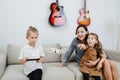 Family spending time on a sofa, playing with quadcopter drone Royalty Free Stock Photo