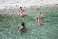 Family spending time together in a crystalclear water of river