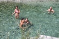 Family spending time together in a crystalclear water of river